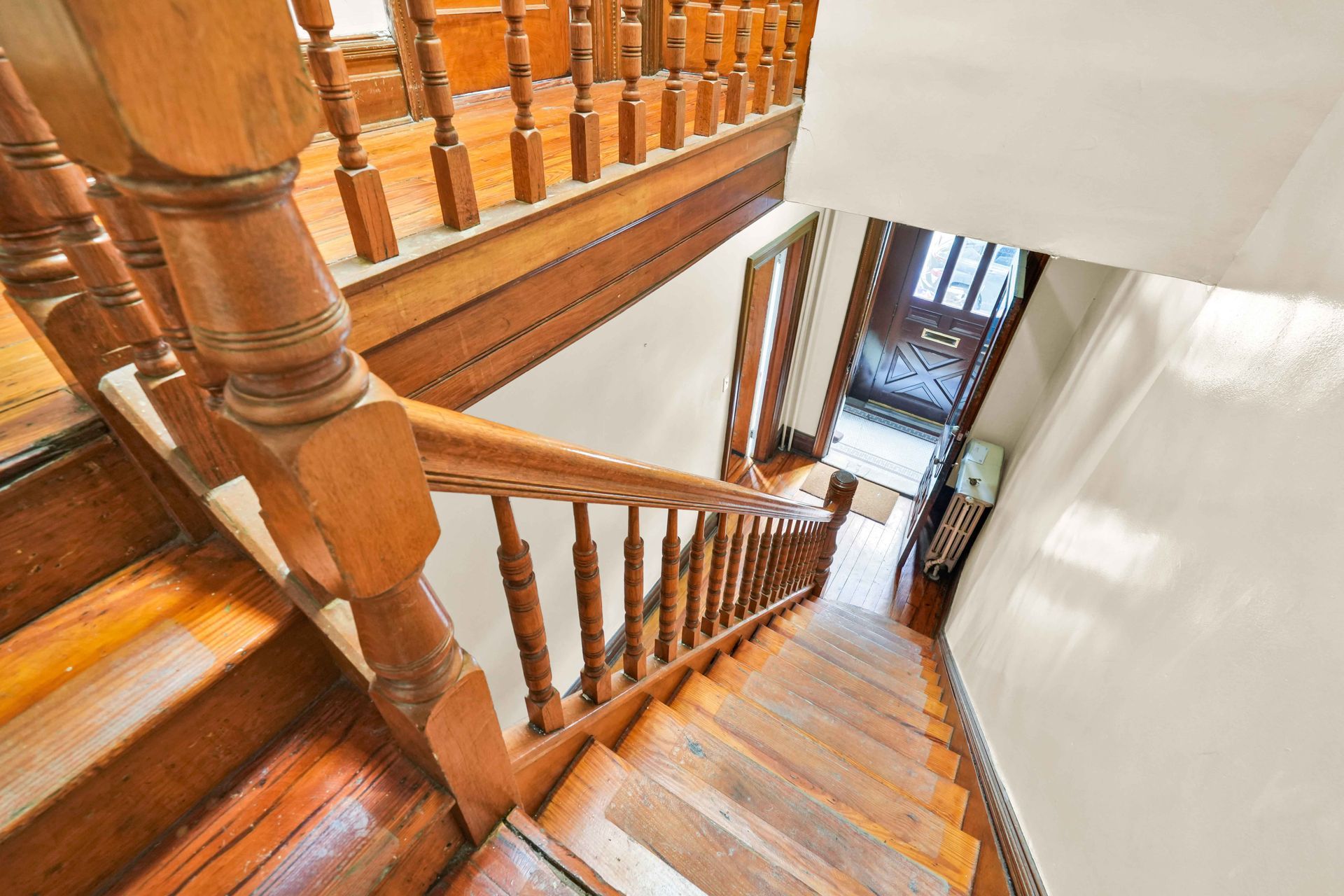 A wooden staircase leading up to the second floor of a house.