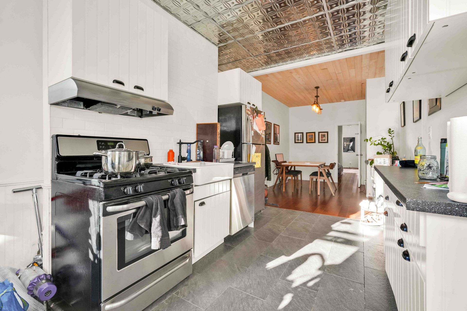 A kitchen with stainless steel appliances and white cabinets