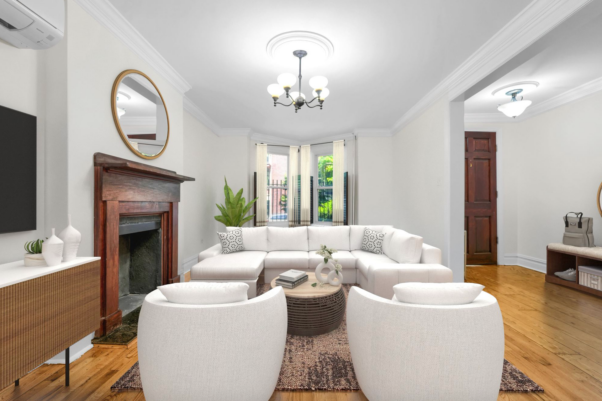 A living room with white furniture and a fireplace.