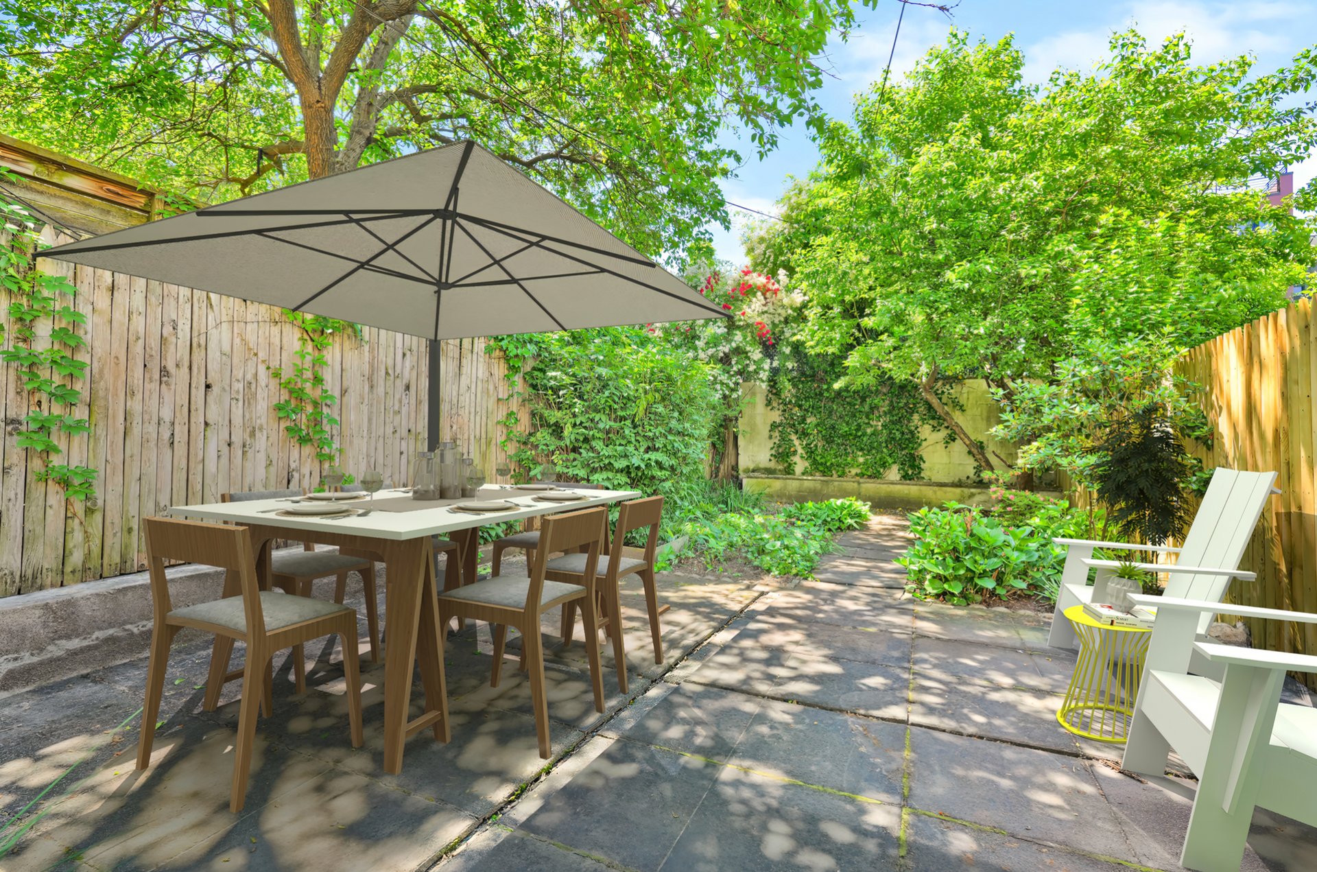There is a table and chairs under an umbrella in the backyard.
