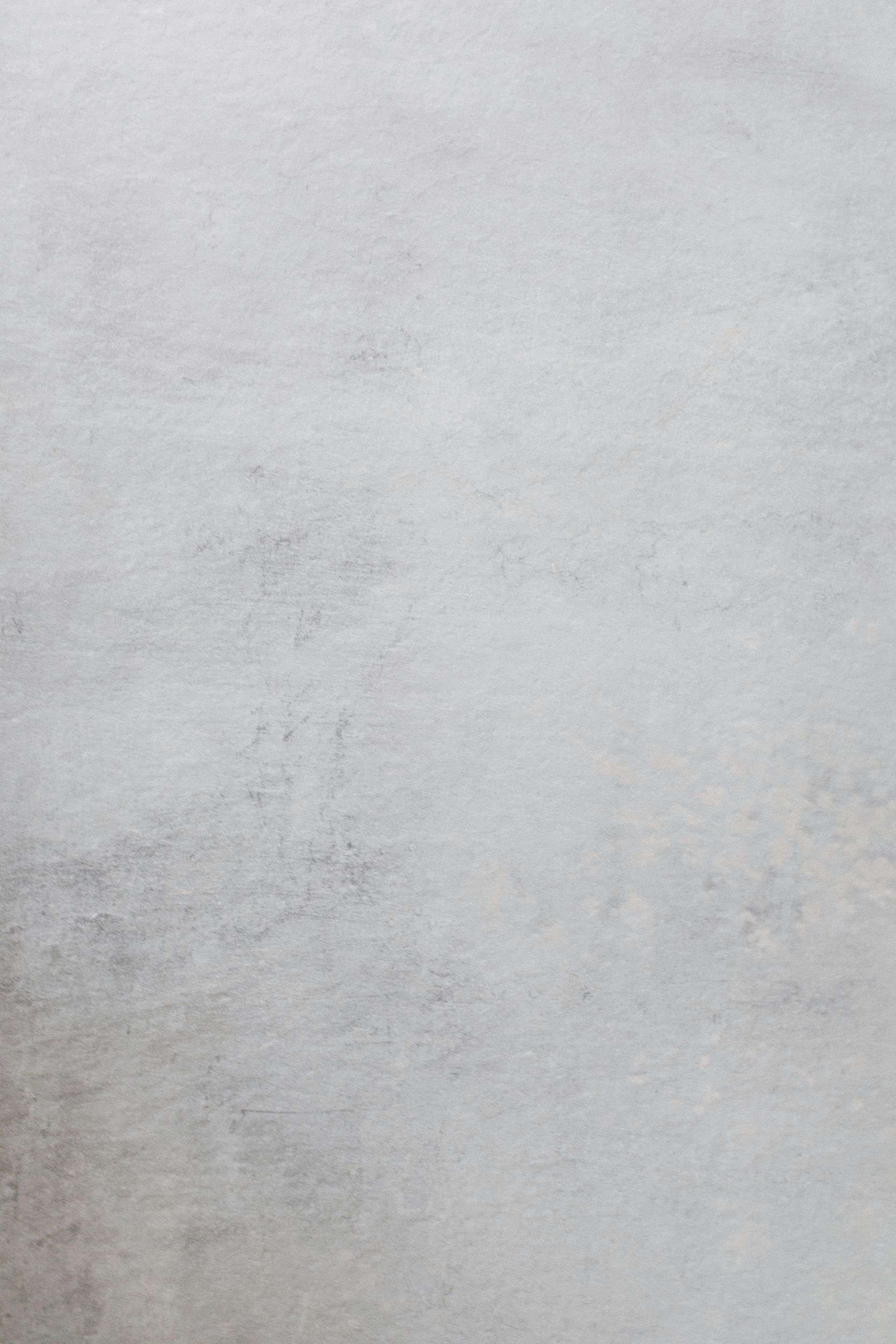 A close up of a white wall with a brush stroke pattern.