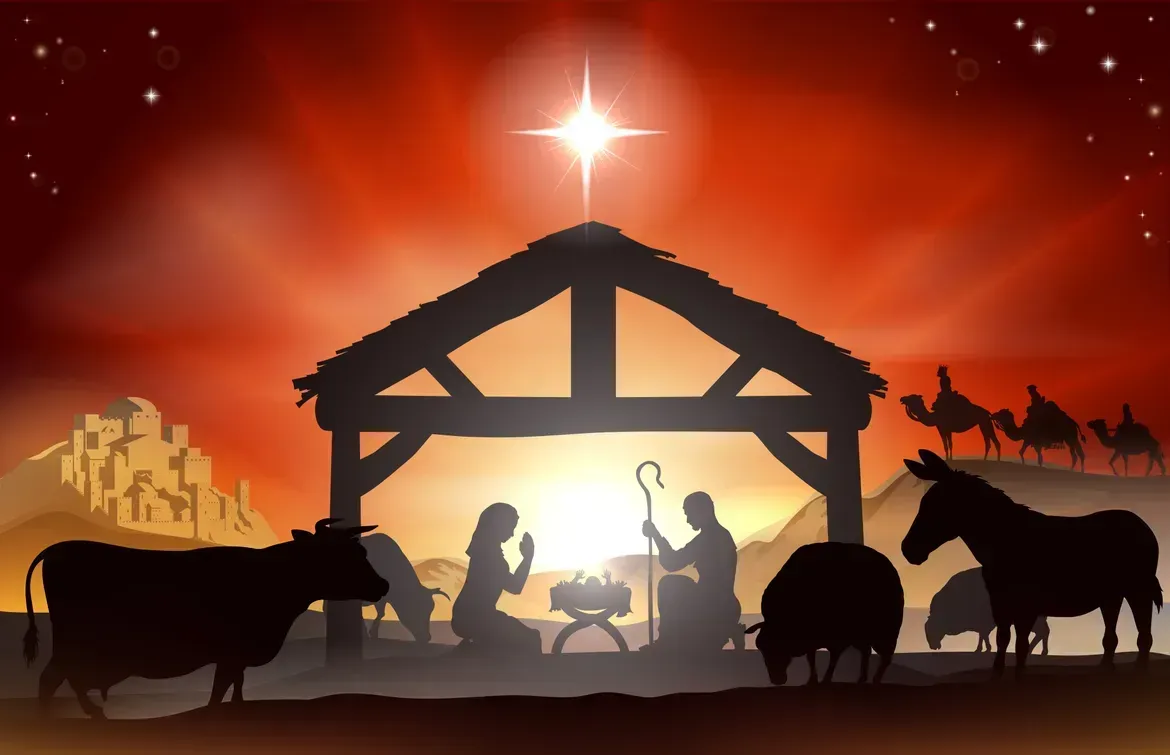 Nativity scene silhouette in a stable at sunset, with star overhead and animals nearby
