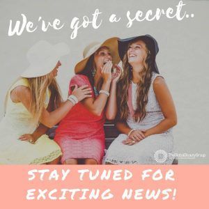 Three women in hats whispering together with text: “We’ve got a secret. Stay tuned for exciting news!”