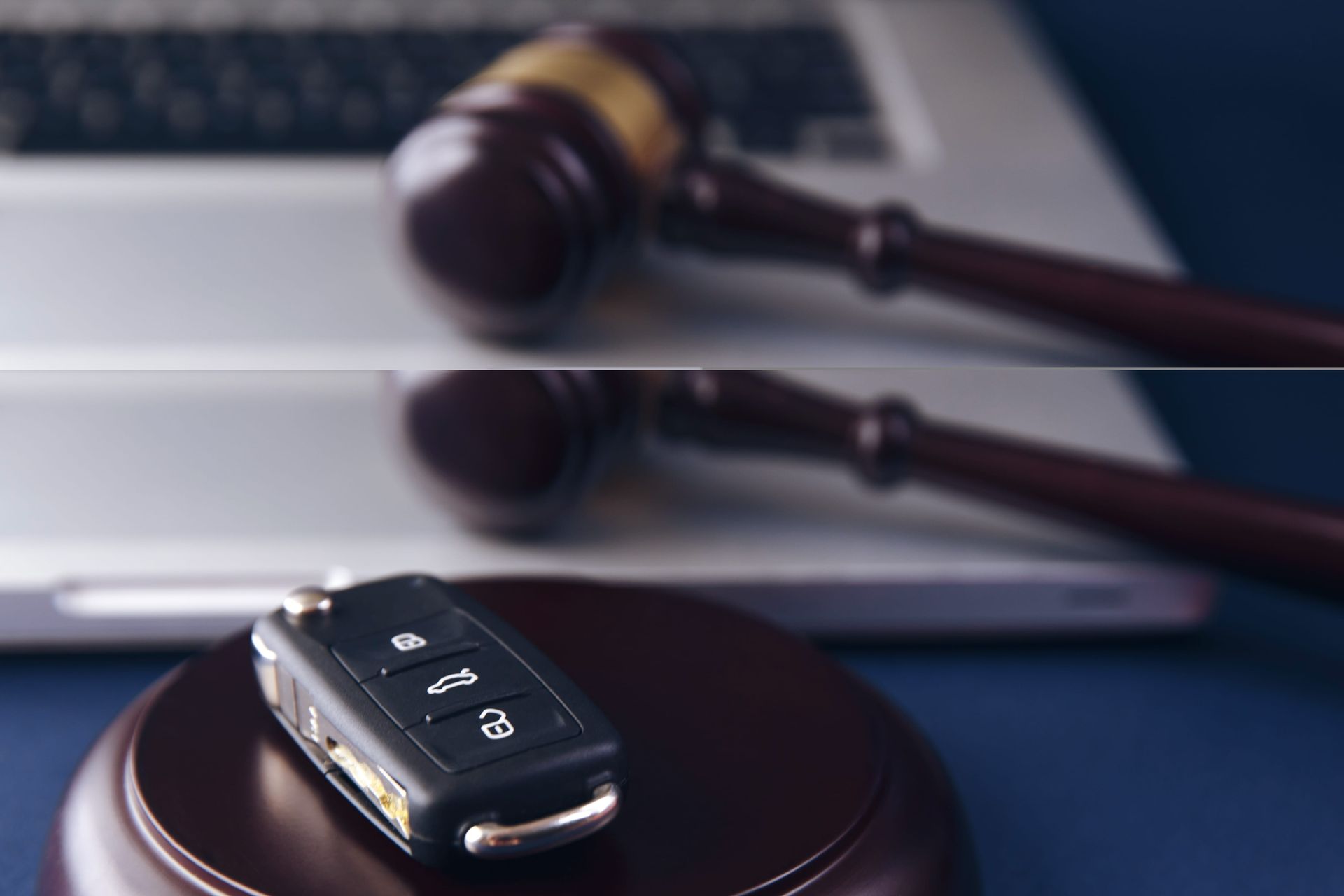Car key fob on a judge’s gavel in a courtroom setting