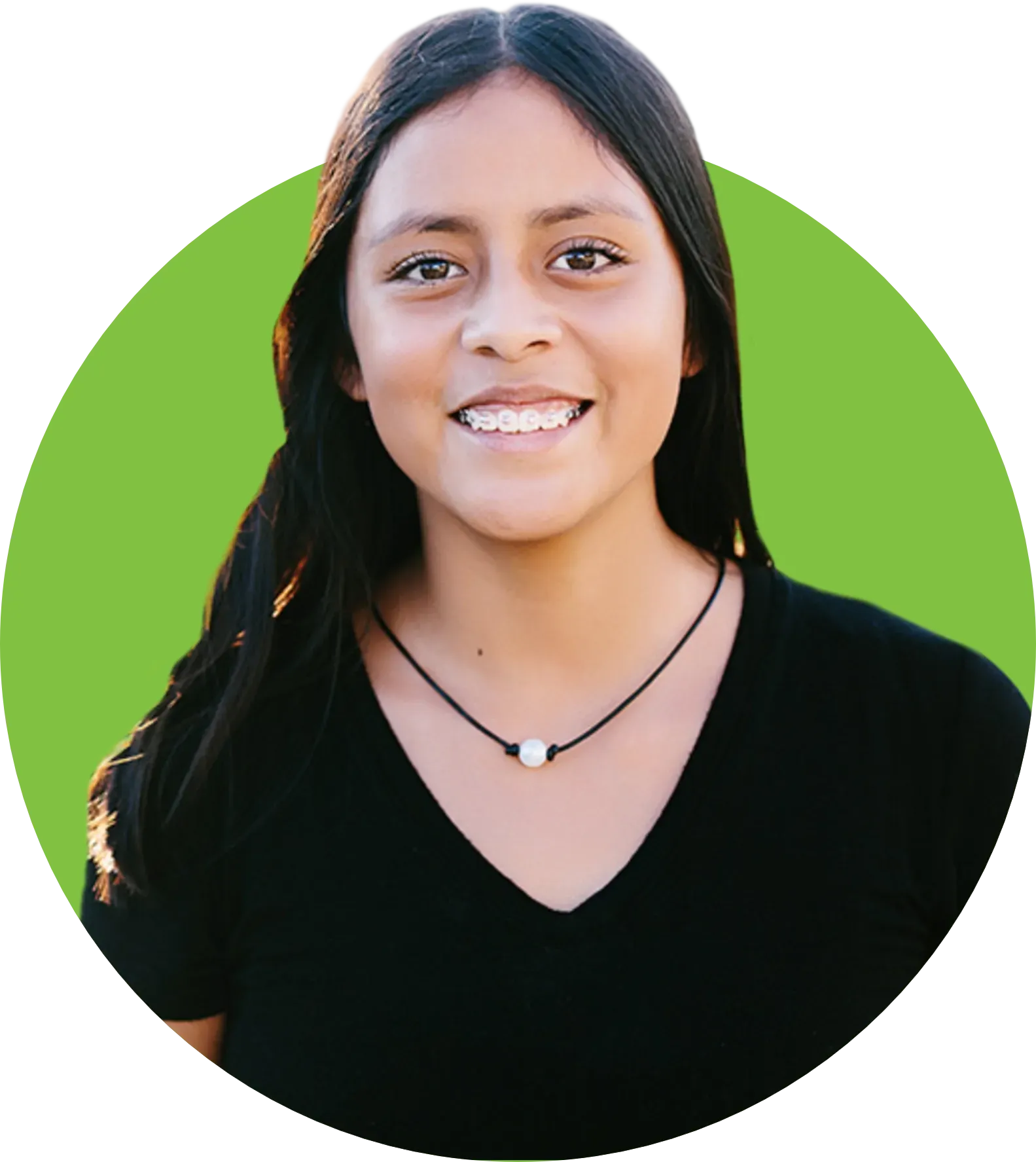 A woman wearing a black shirt and a necklace is smiling in a green circle.