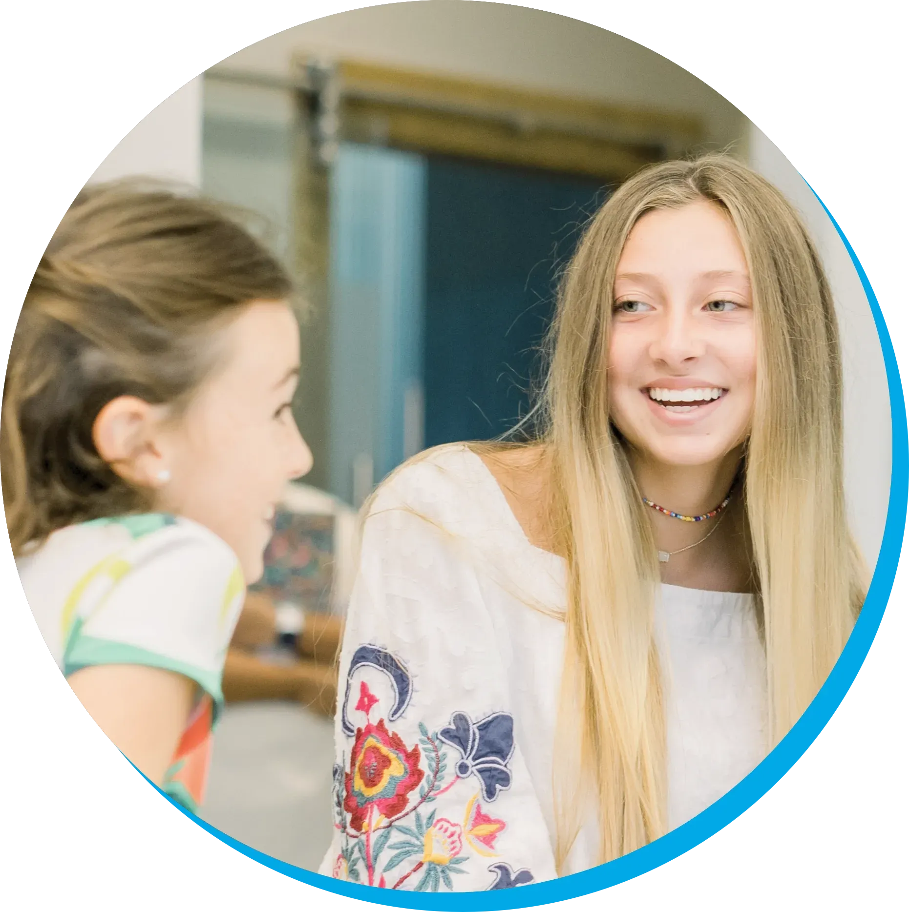 A woman and a little girl are talking to each other in front of a mirror.