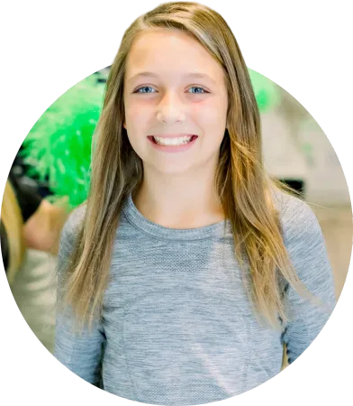 A young girl is smiling for the camera in a circle.