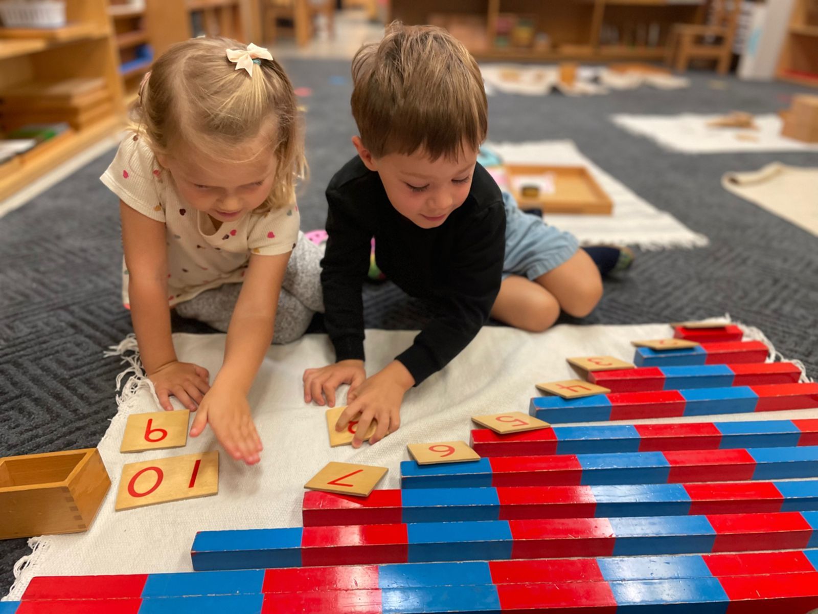 Montessori child working with number rods and number cards