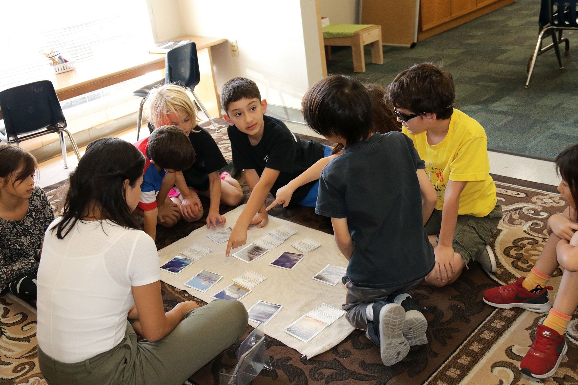 Teacher sitting with students during a work period