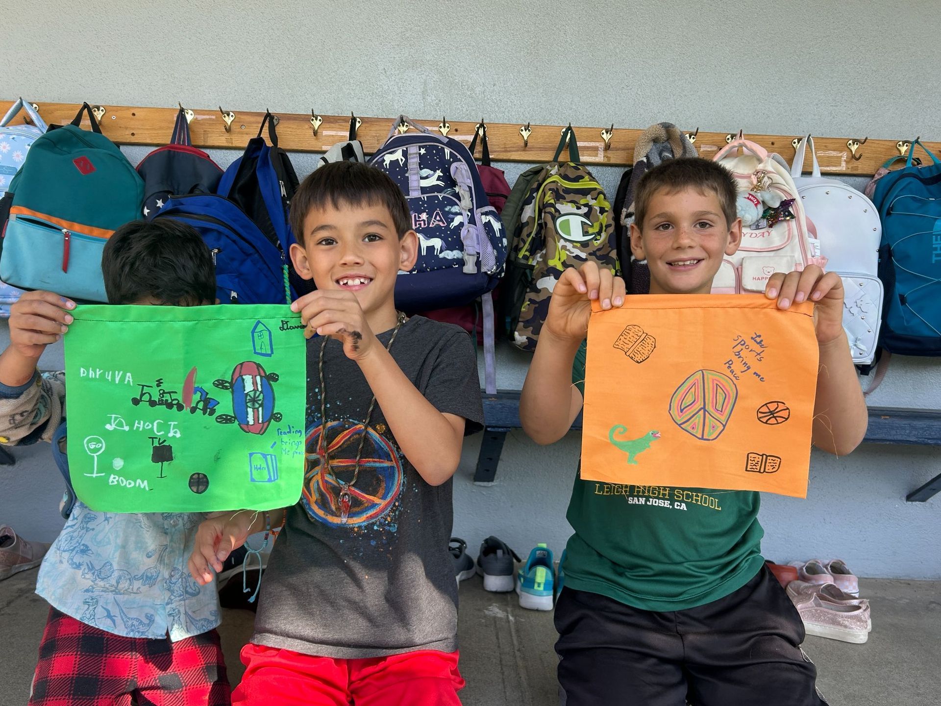 Montessori students painting outdoors