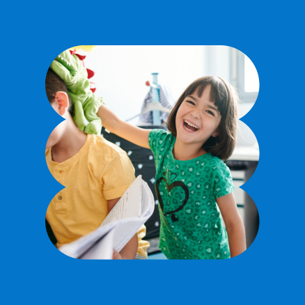 A little girl wearing a green shirt with a heart on it