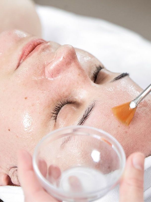 woman receiving a peel treatment procedure