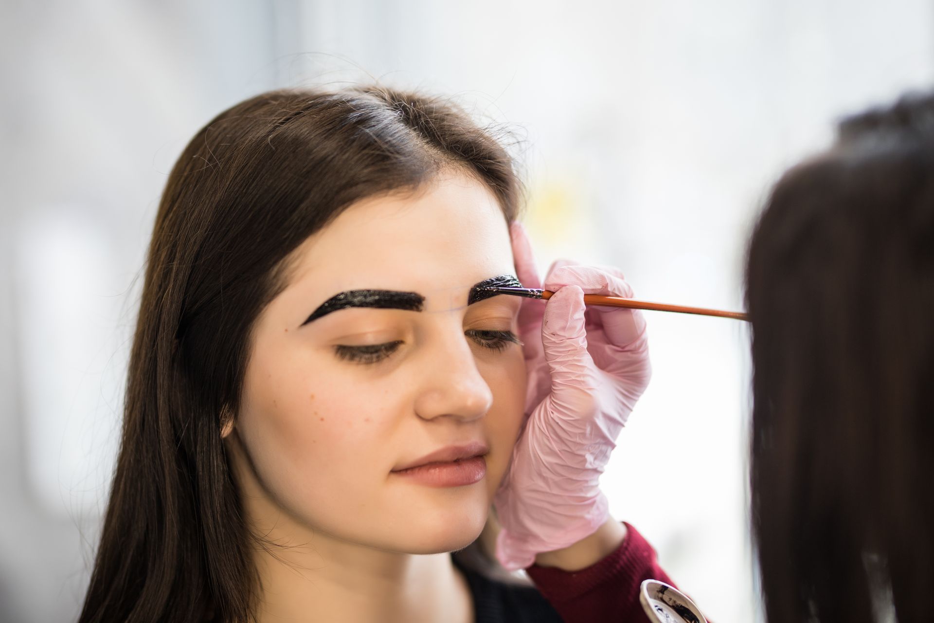 woman getting eyebrows tinted