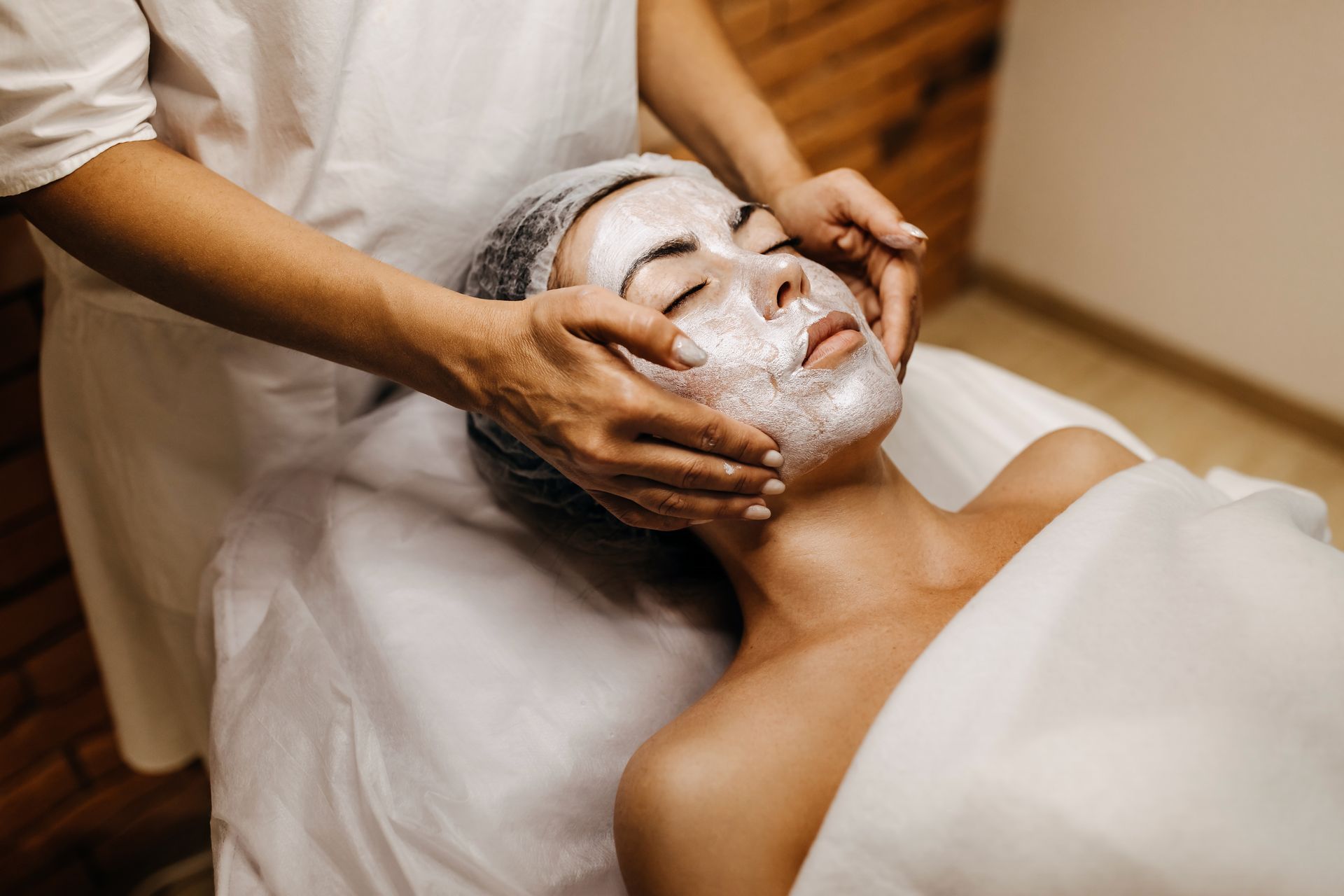 A woman is getting a facial treatment at a spa.