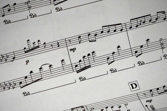 Musical score, featuring staves, notes, dynamic markings (p, mp), and slurs. A 