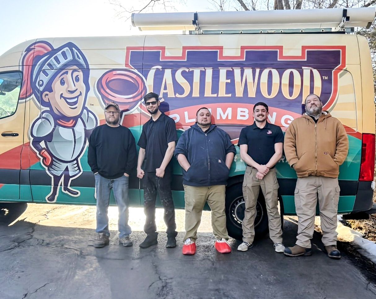 Five men standing in front of a Castlewood Campers mural on a sunny day.