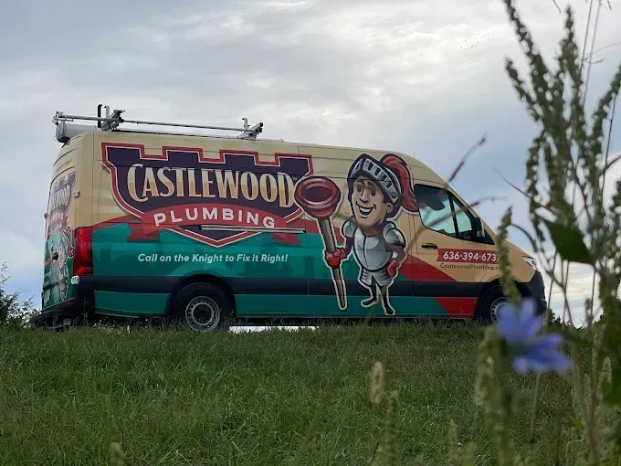 Castlewood Plumbing van with knight mascot parked on a grassy hill; cloudy sky in the background. Castlewood Plumbing van with knight mascot parked on a grassy hill; cloudy sky in the background.