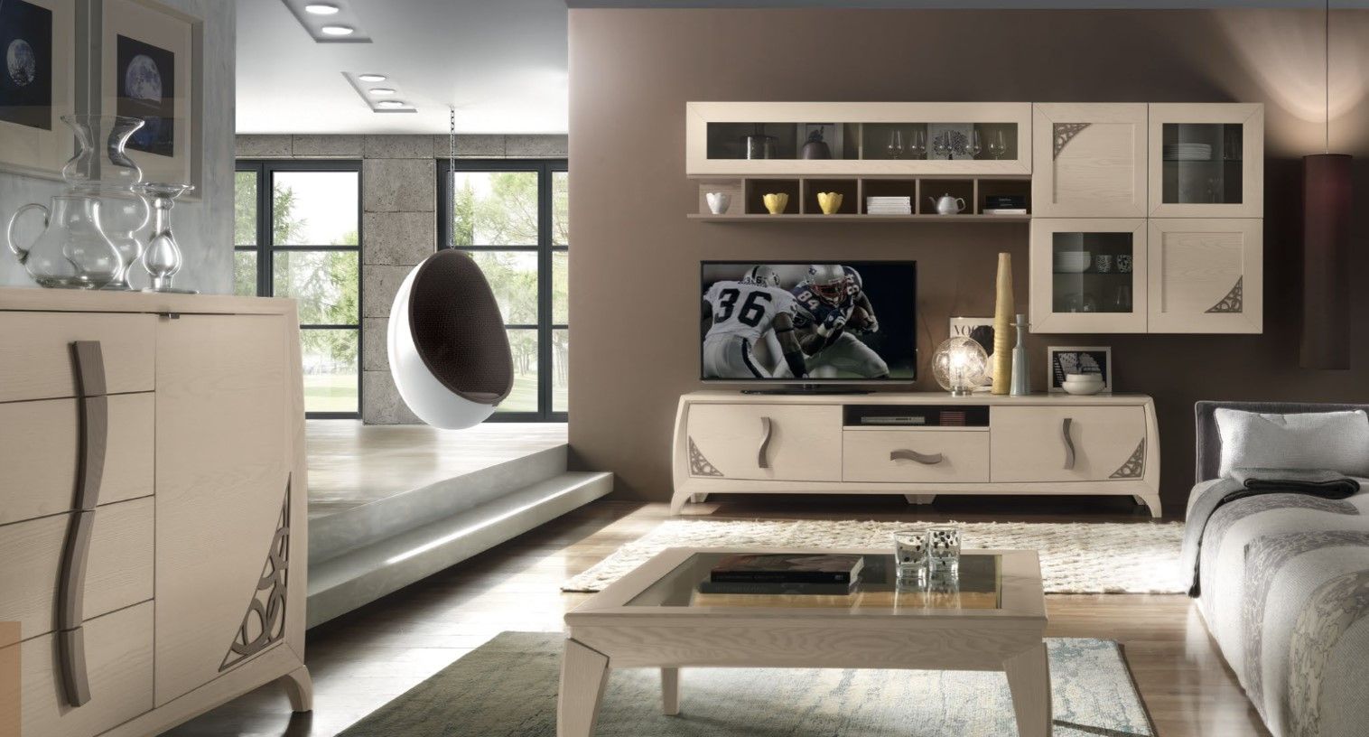 Soggiorno dal design moderno, dotato di televisore, mobili e poltrona sospesa.