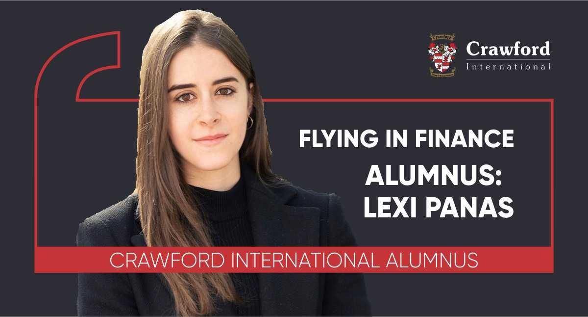 A woman is sitting in front of a sign that says flying in finance.