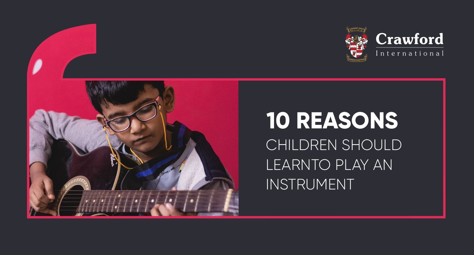 A young boy is playing a guitar on a red background.