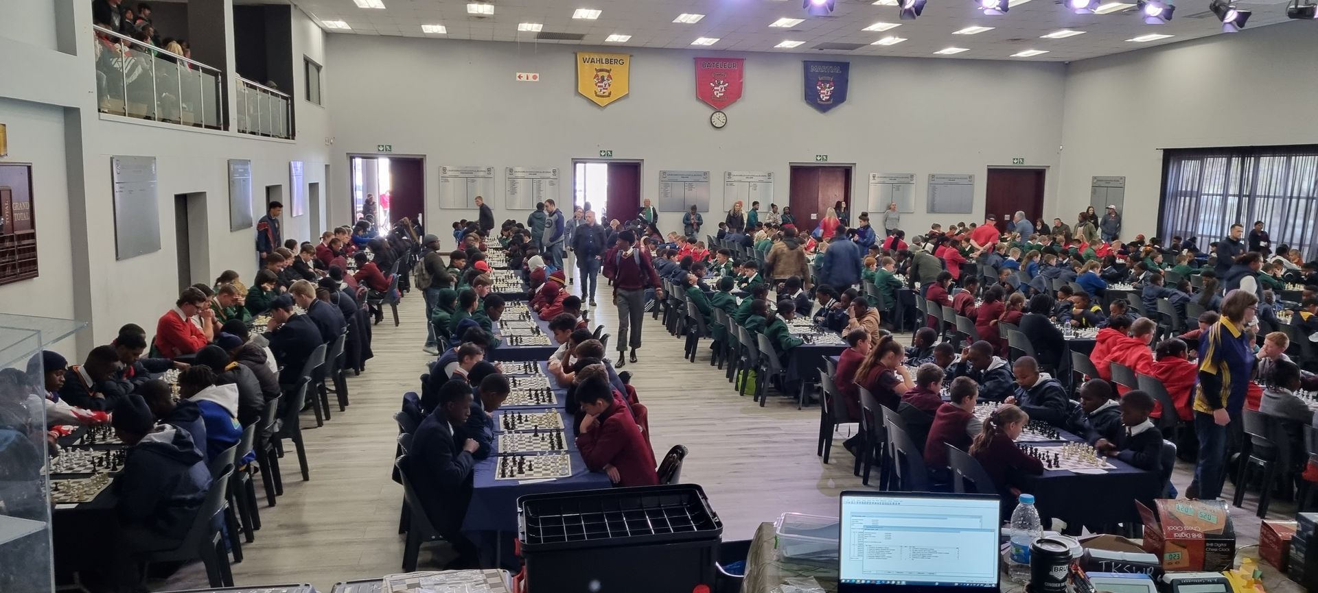 A large group of people are sitting at tables in a large room.