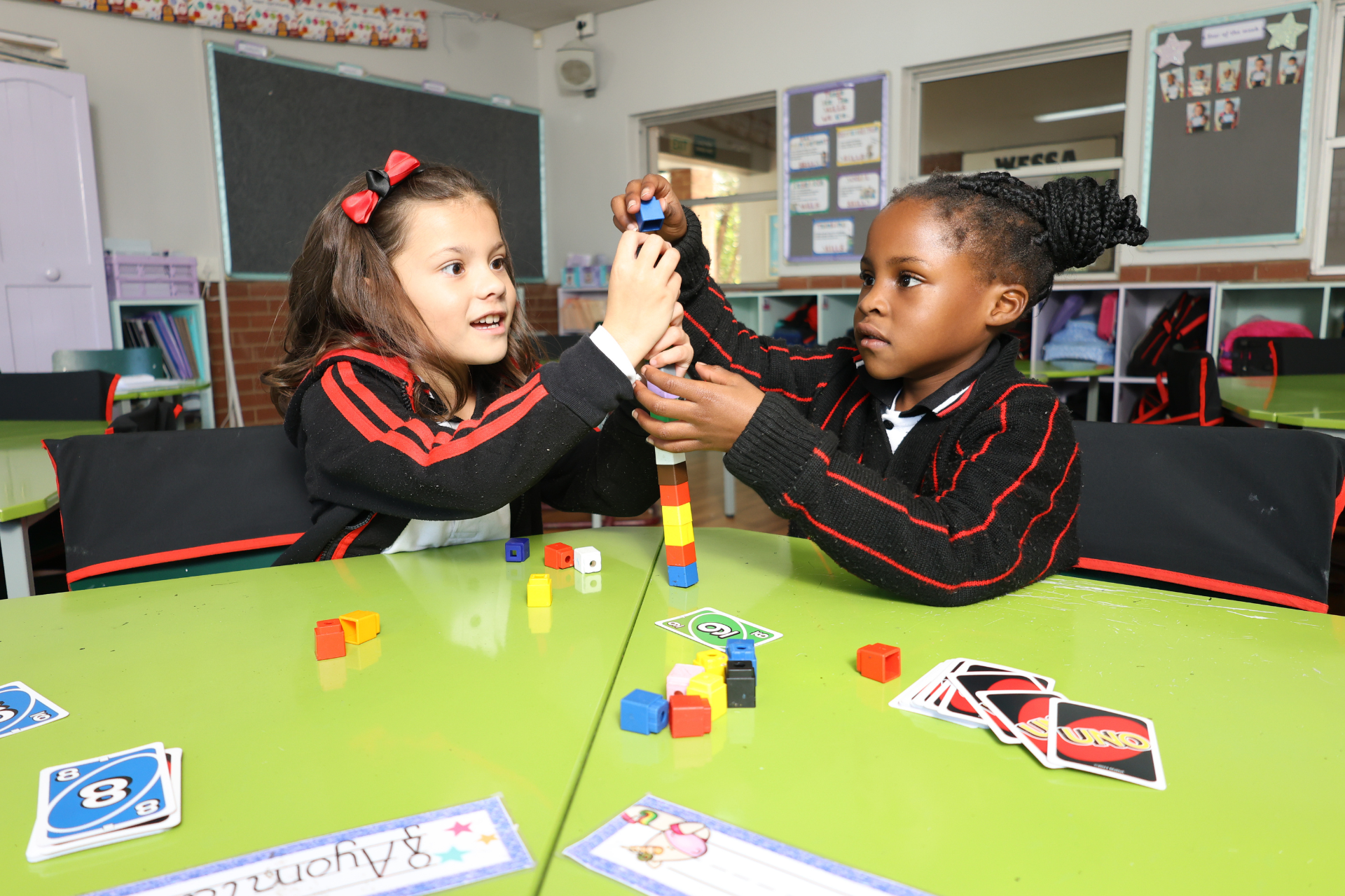a group of children are sitting at desks in a classroom .