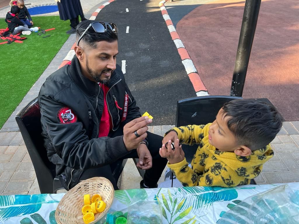 A man is sitting at a table with a child.