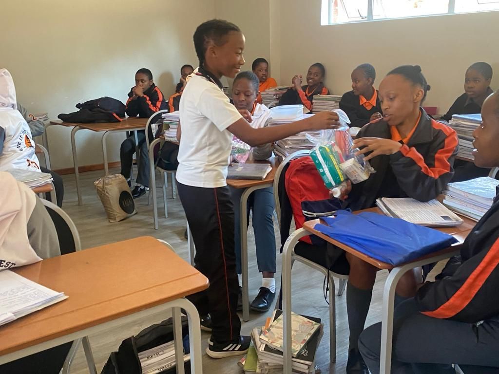 A group of children are sitting at desks in a classroom.