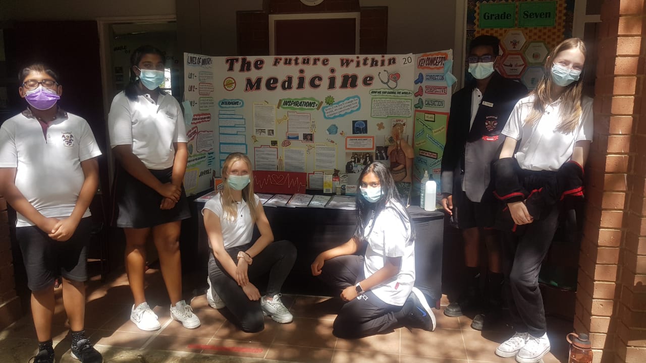 A group of young people wearing face masks are posing for a picture.