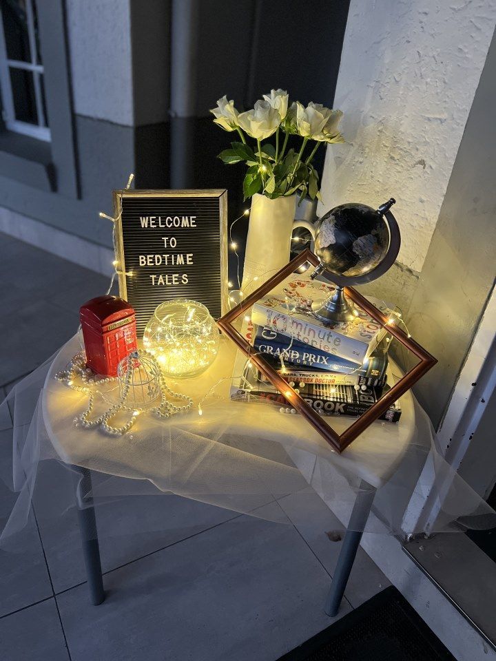 A table with a sign that says welcome to bedtime tales on it.