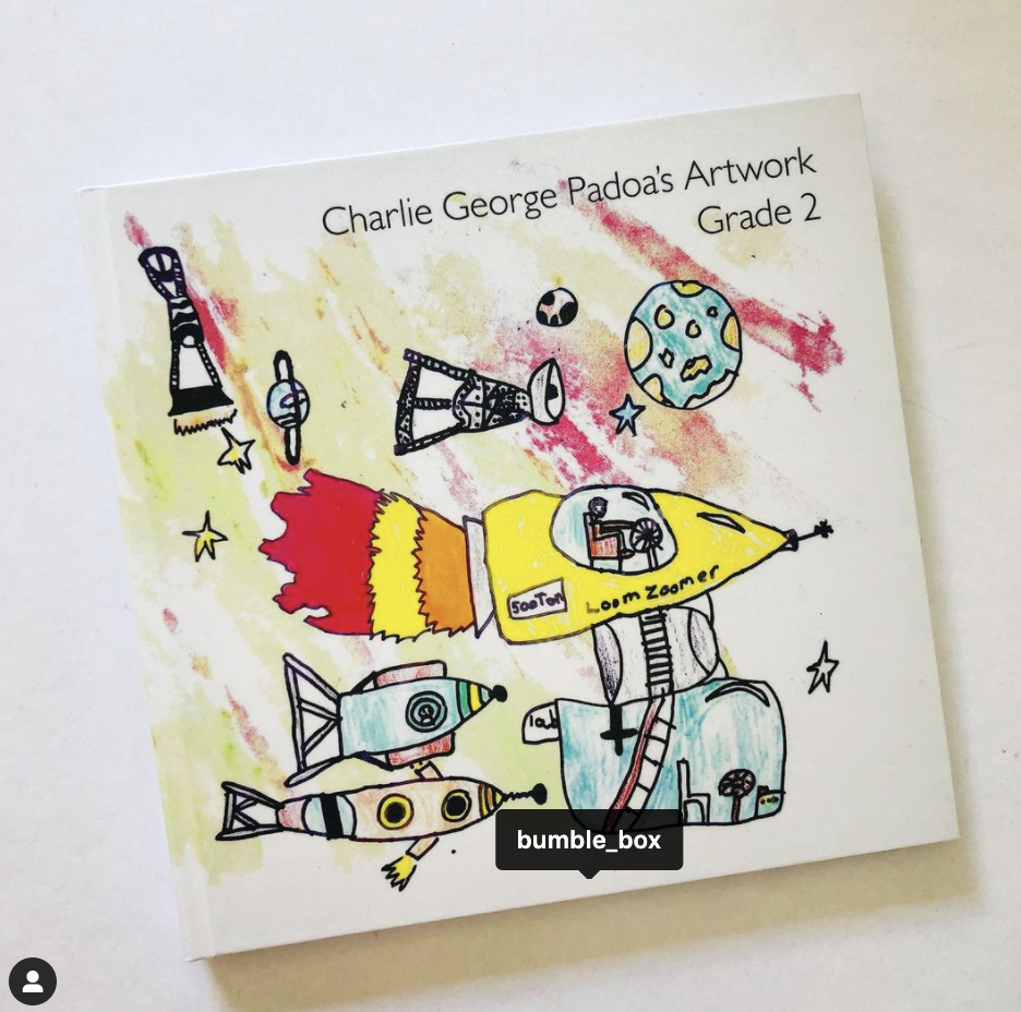 A child 's drawing of a rocket is on the cover of a book