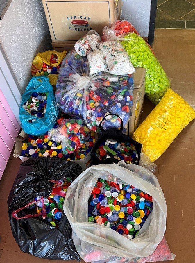A pile of plastic bottle caps in bags and boxes