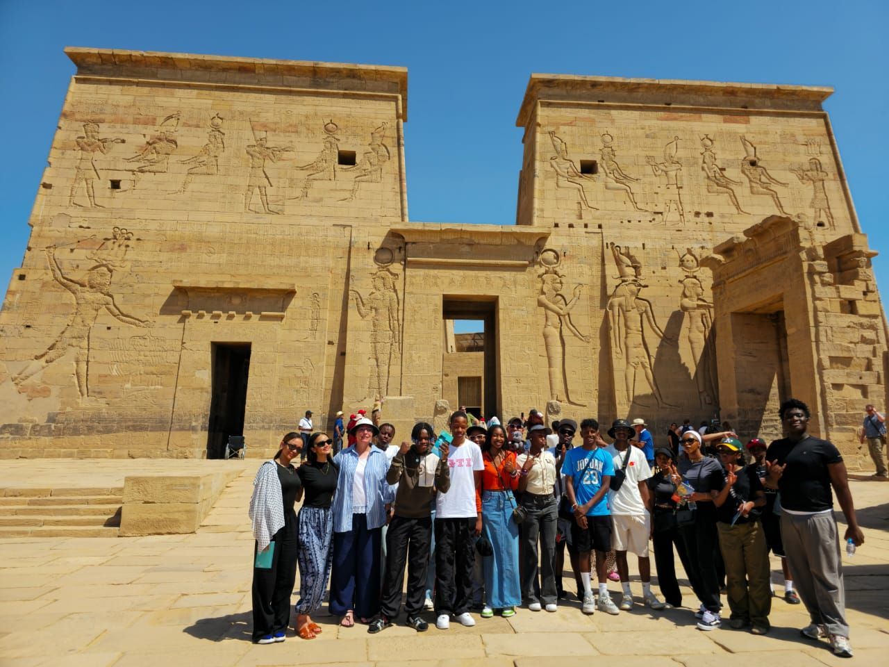 A group of people posing for a picture in front of an ancient building