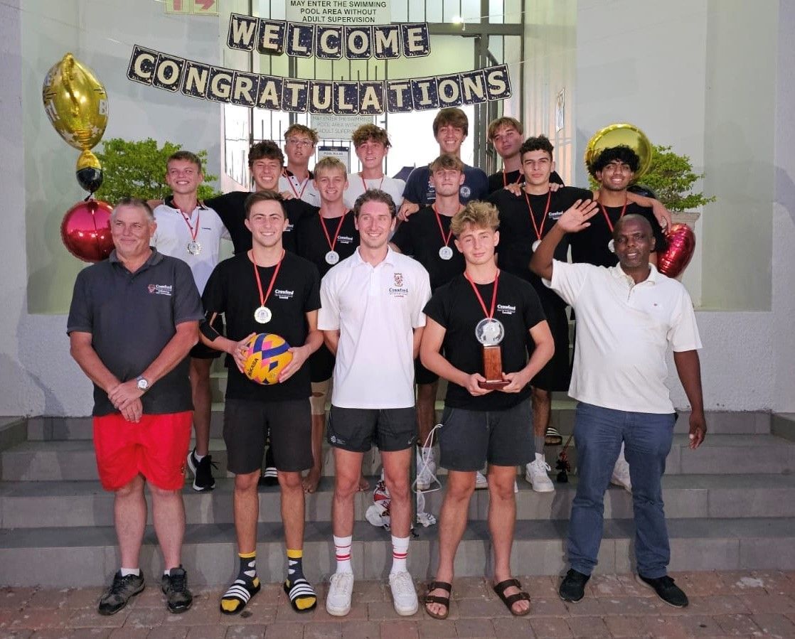 A group of people standing in front of a sign that says welcome congratulations