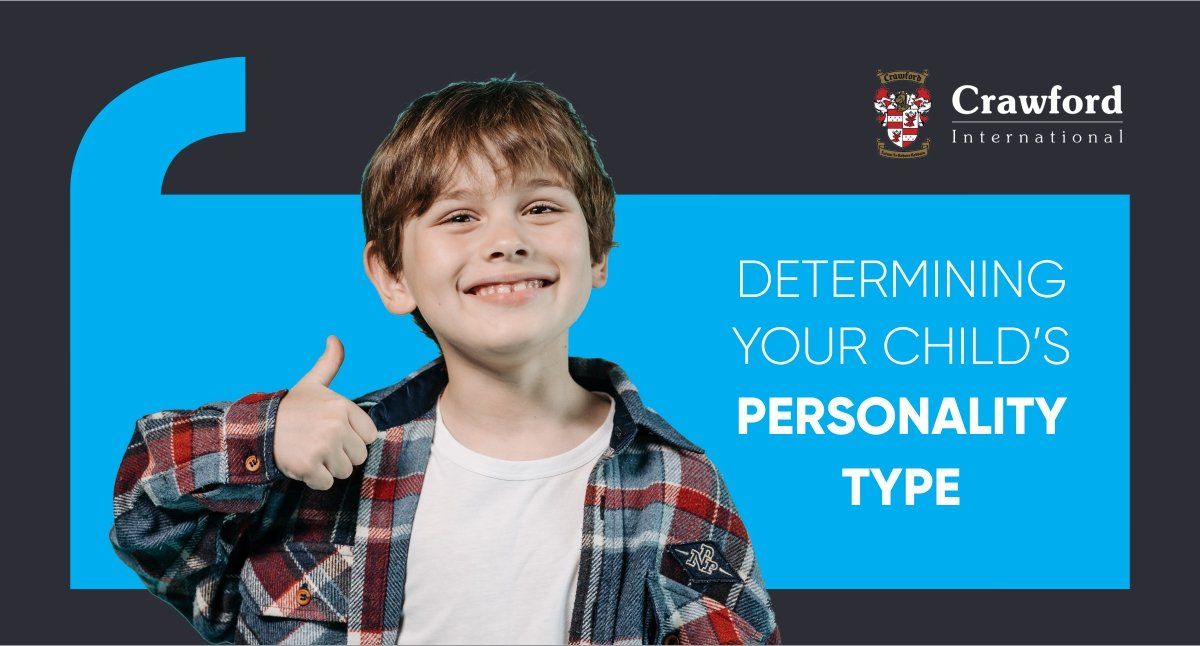 A young boy in a plaid shirt is giving a thumbs up.