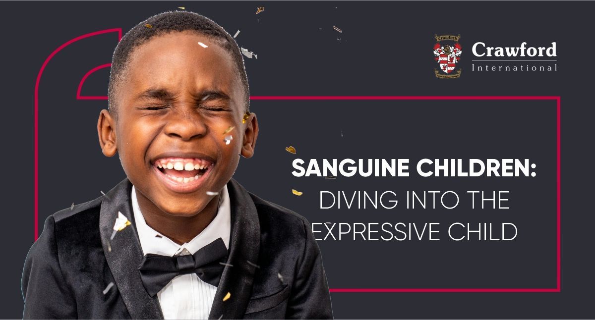A young boy in a tuxedo and bow tie is laughing.