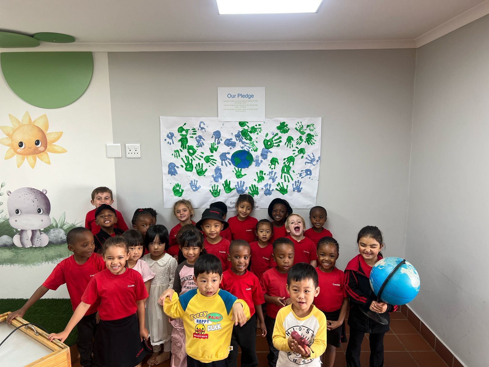 A group of children are posing for a picture in a room.