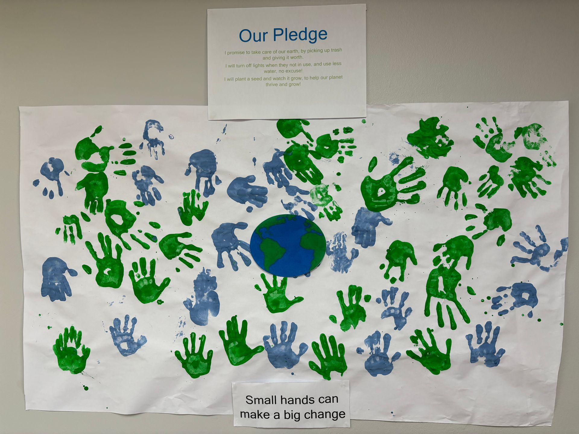 A poster with handprints on it that says our pledge