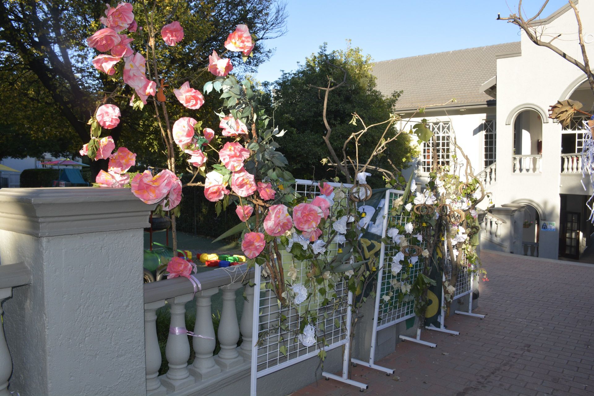 A fence with pink and white flowers on it