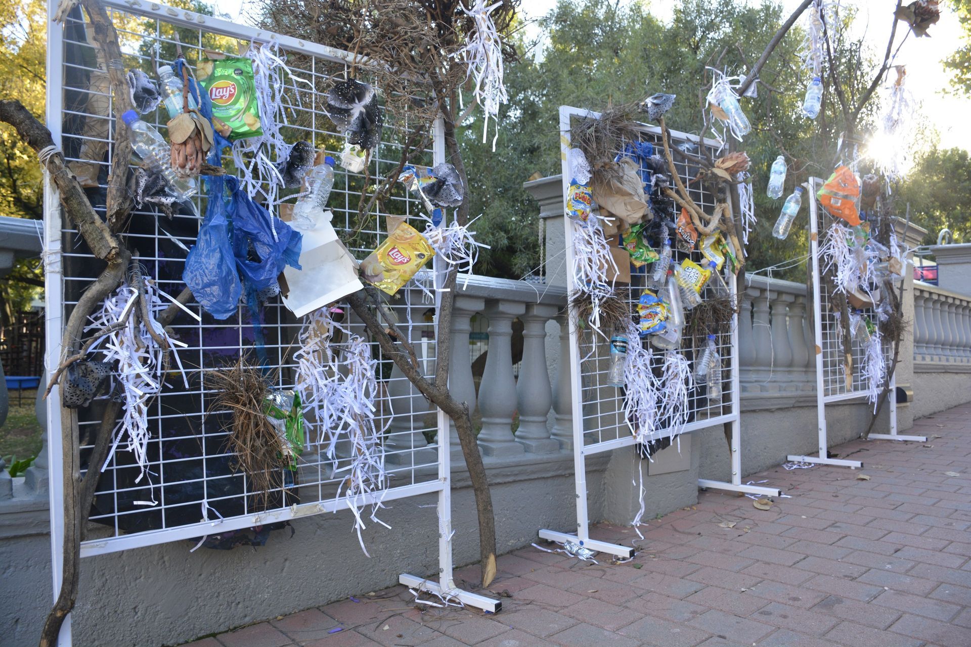 A fence with a bunch of trash hanging from it