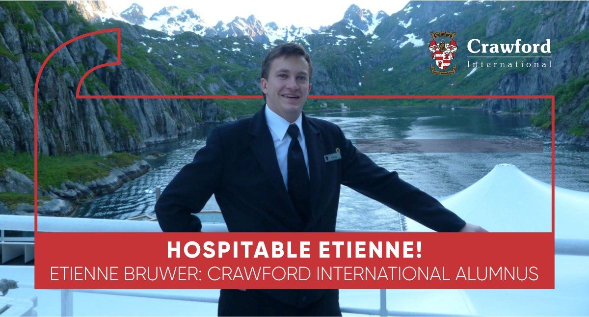 A man in a suit and tie is standing in front of a river