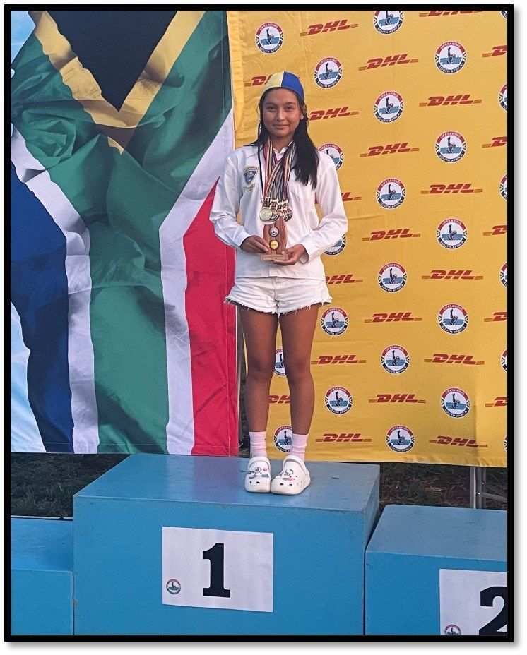 A girl is standing on a podium with the number 1 on it