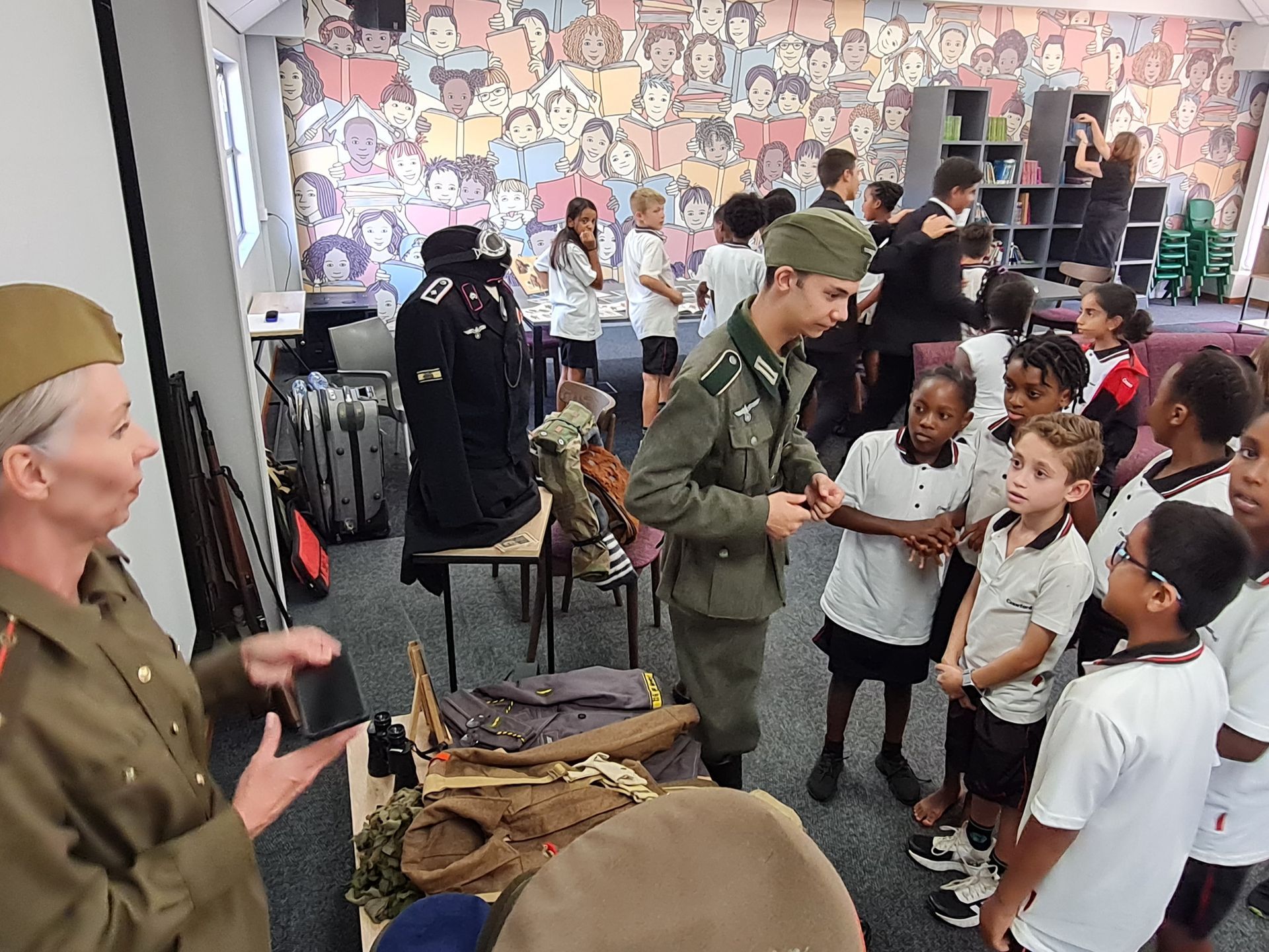 A group of children are standing around a man in a military uniform.