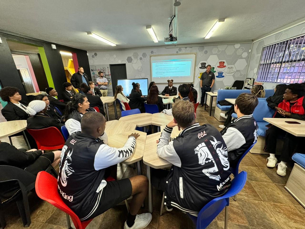 A group of people are sitting around a table in a room.