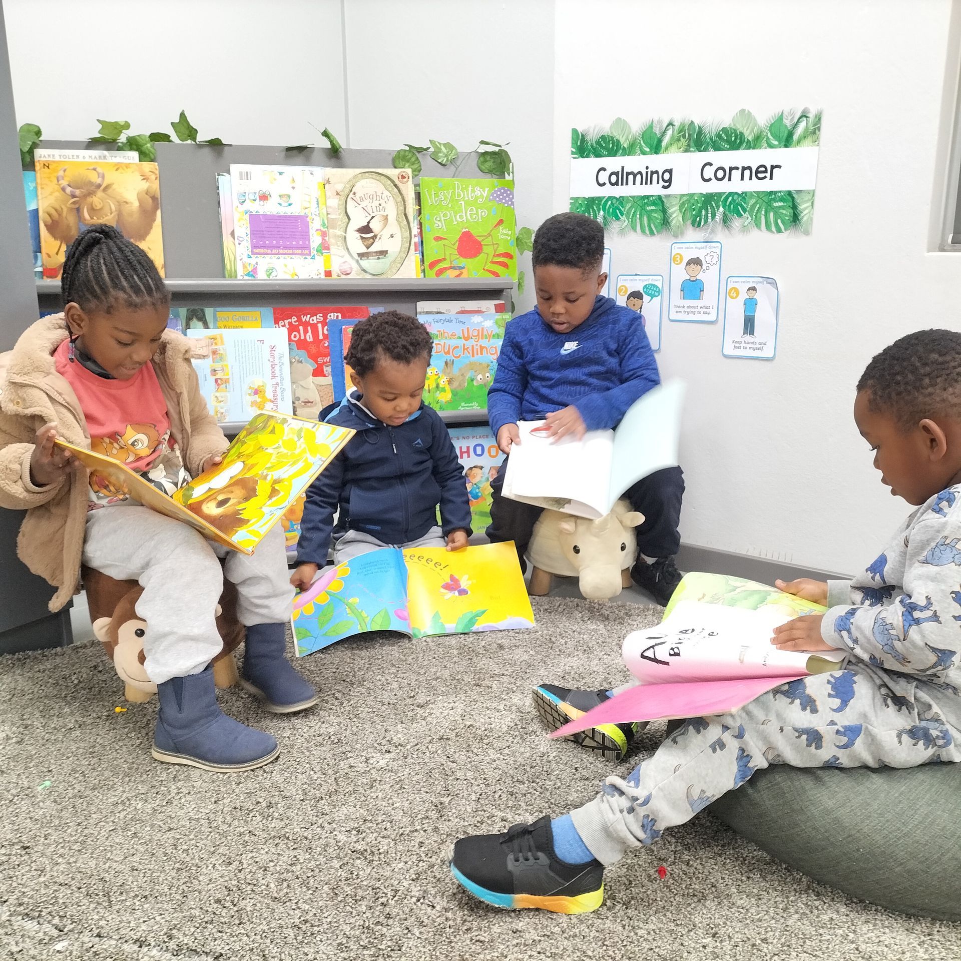 A group of children are sitting on the floor reading books.