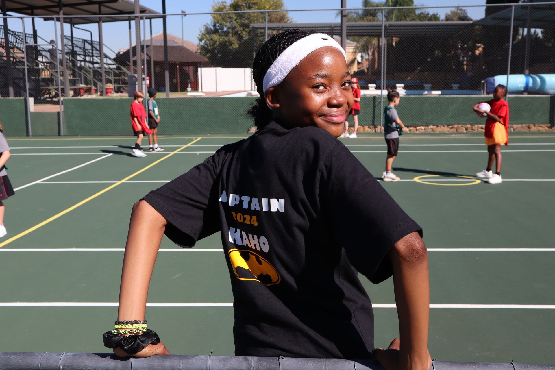 A girl wearing a black shirt that says captain on it