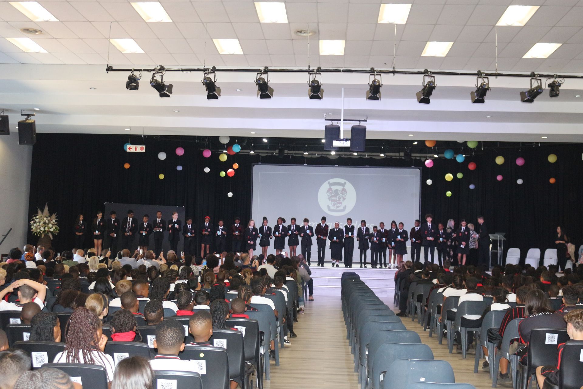 A large auditorium filled with people watching a concert