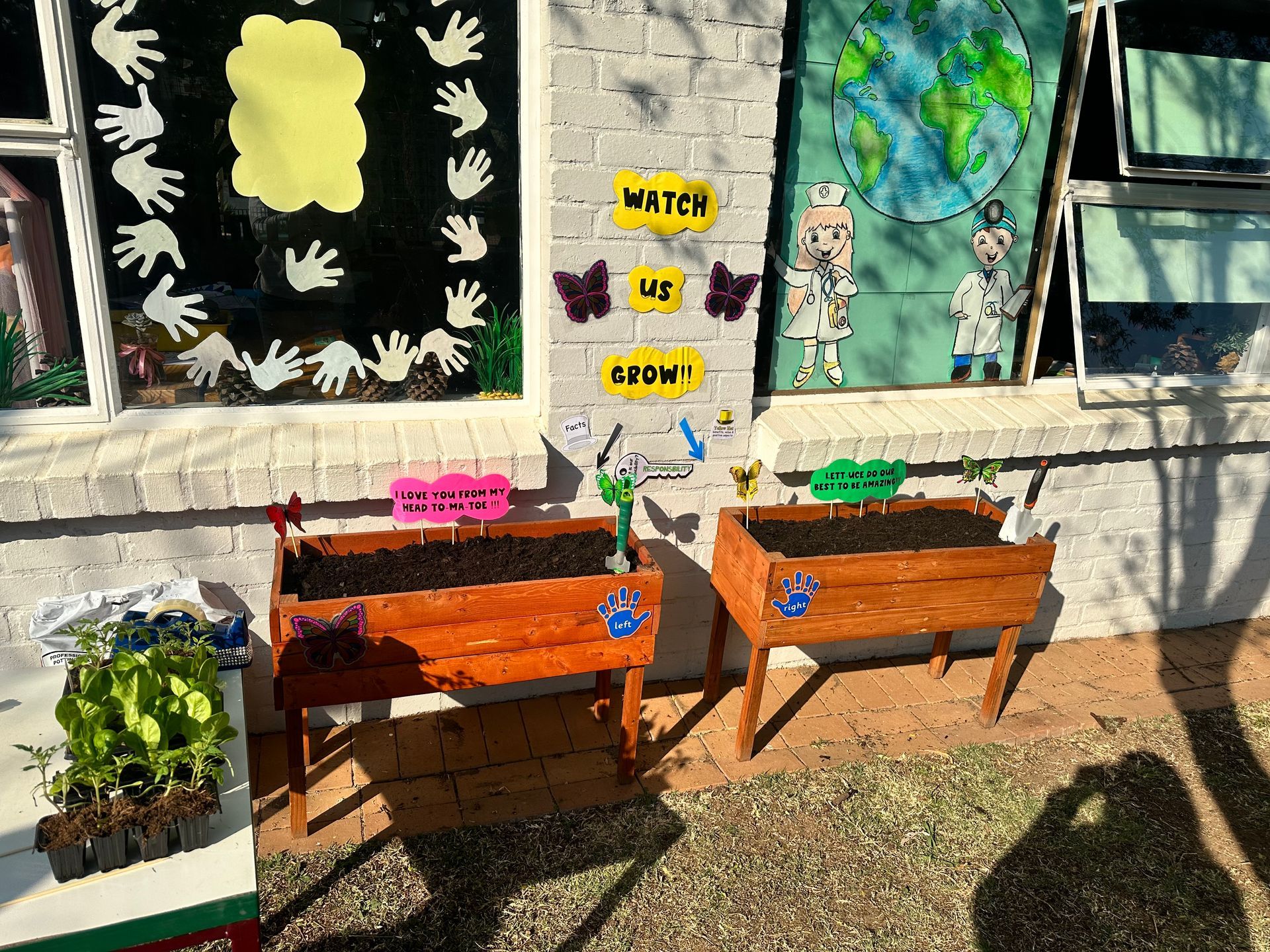 A group of wooden planters are sitting in front of a window.