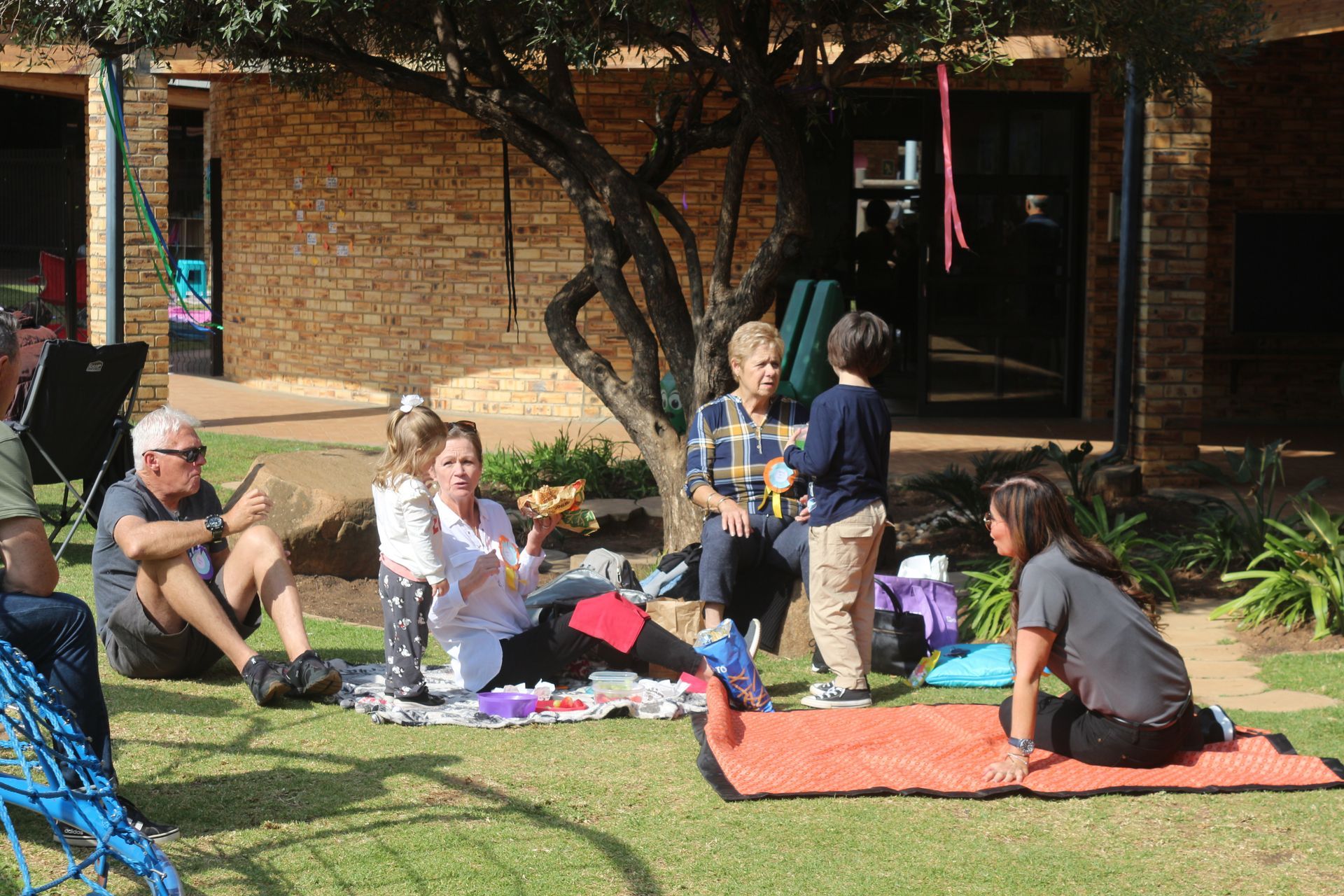 A group of people are having a picnic in the grass.