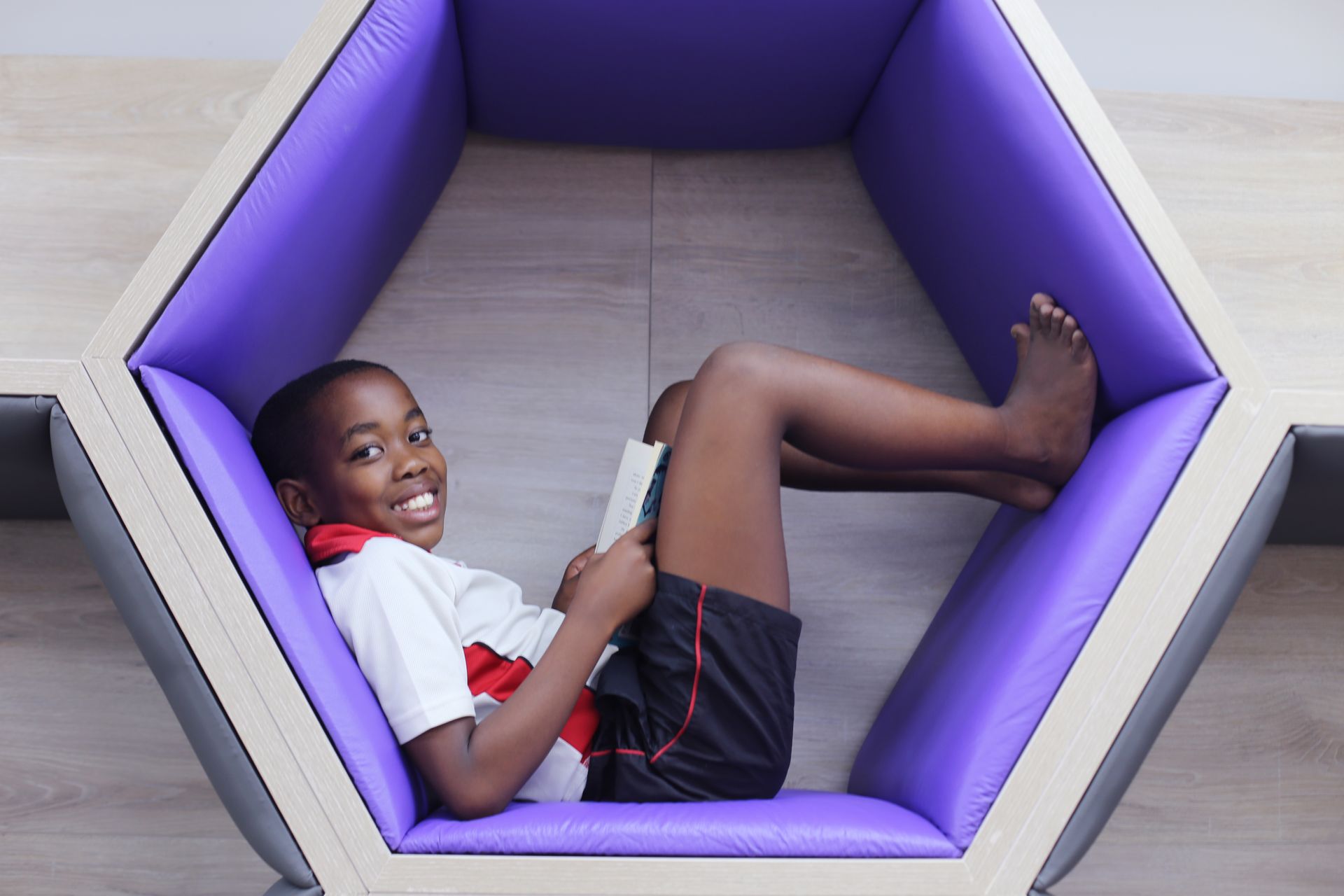 Little boy lying inside hexagon
